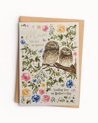 Greeting card for Mother's Day with owls and floral design on a white background